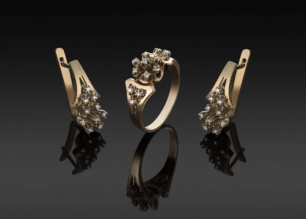Gold rings and earrings with diamonds laid out for appraisal