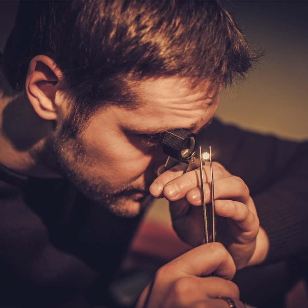 Buyer inspecting a gold chain and rings during a free in-store evaluation