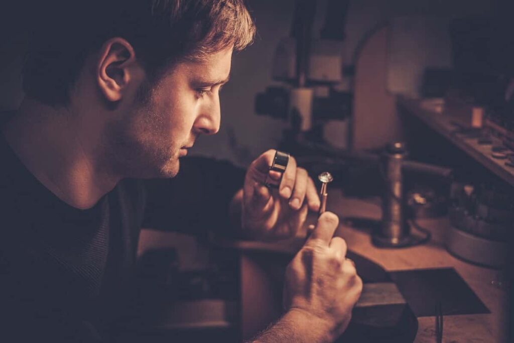 Kelowna gold buyer examining a gold ring under a microscope during an evaluation