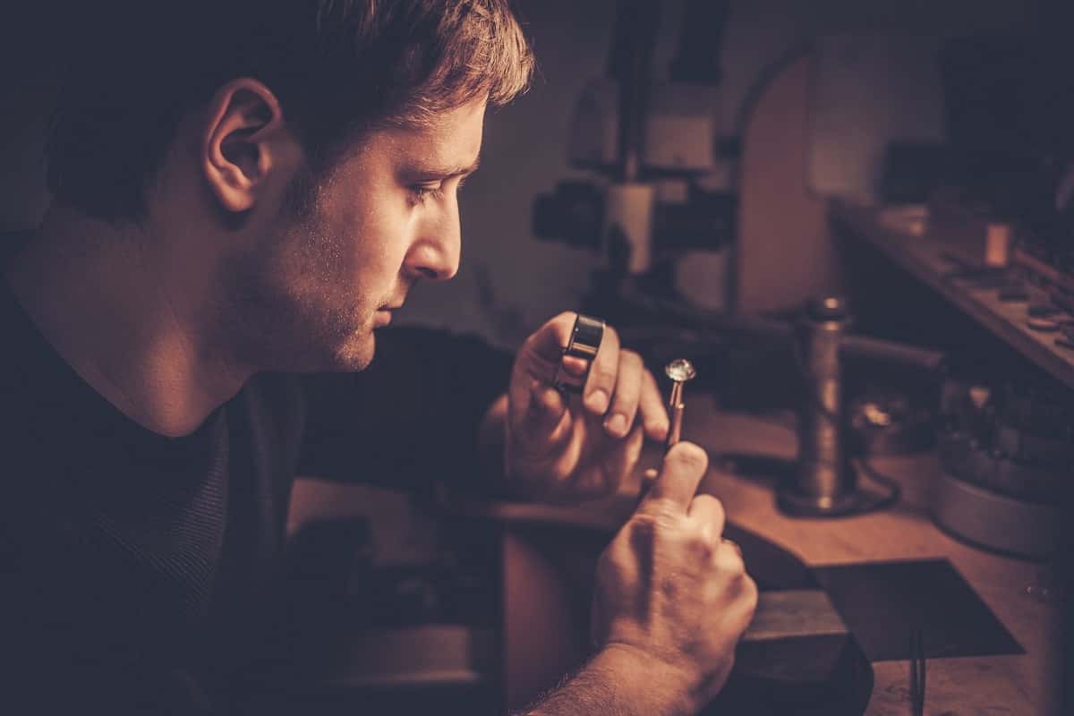 Kelowna gold buyer examining a gold ring under a microscope during an evaluation